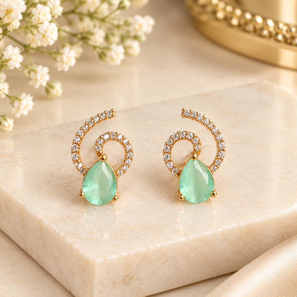 Twisted white stones with an aqua blue drop stone.